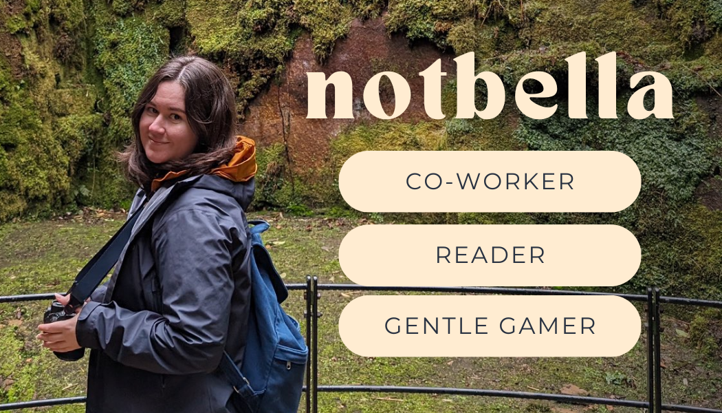 photo of Bella holding a camera and looking over their shoulder in front of a mossy rock. The image says &ldquo;notbella, co-worker, reader, gentle gamer.&rdquo;